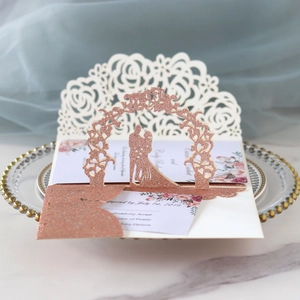 Vue macro d'invitation de mariage pop-up en or rose avec silhouette romantique et fleurs