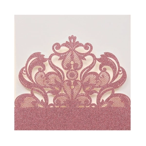 Detail of pink glitter laser-cut wedding invitation card with lace floral pattern