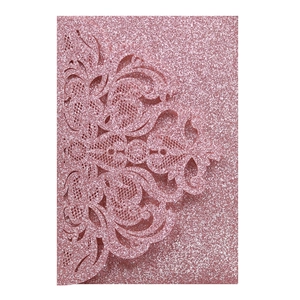 Detail of pink glitter laser-cut floral wedding invitation card with pearlescent finish
