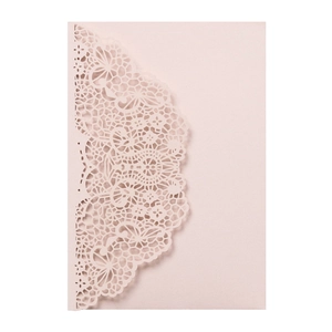 Detail of laser-cut lace floral pattern on pearlescent pale pink wedding invitation