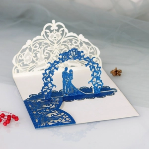 Detail of 3D laser-cut wedding card featuring a romantic couple silhouette under a floral arch