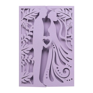 Macro detail of laser-cut lavender wedding invitation with bride and groom silhouette