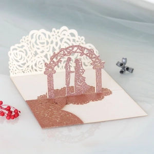 Detail of 3D pop-up wedding card with laser-cut rose gold glitter couple silhouette