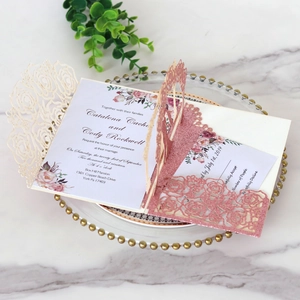 Detail of rose gold glitter laser cut floral wedding invitation with RSVP card set