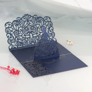Detail of laser-cut navy blue wedding invitation with elegant girl silhouette and lace patterns