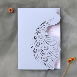 Detailed laser-cut peacock wedding invitation in lavender pearlescent paper