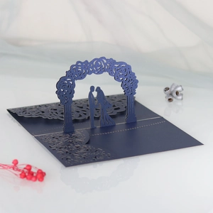 Detail of 3D laser cut wedding invitation card with rose arch and couple silhouette