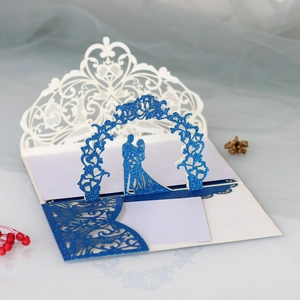 Detail of 3D laser-cut wedding invitation featuring blue glitter and couple silhouette