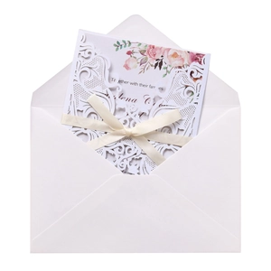Laser-cut hollow wedding invitation set with floral inner card and white ribbon bow