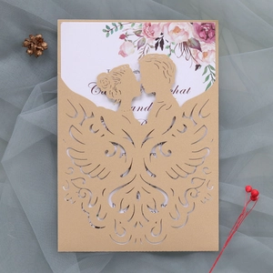 Detail of laser-cut wedding invitation featuring a couple silhouette and floral inner card