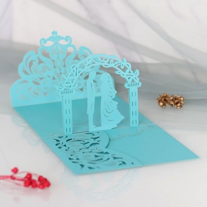 Detailed 3D laser-cut wedding card featuring a sky blue silhouette of a couple in a gate
