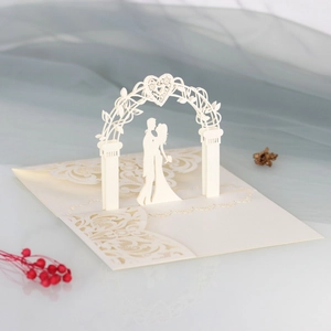 3D laser-cut wedding card featuring a romantic couple under an ivory heart archway