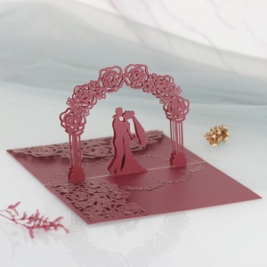 Detailed laser-cut 3D wedding invitation featuring a burgundy rose arch and couple silhouette