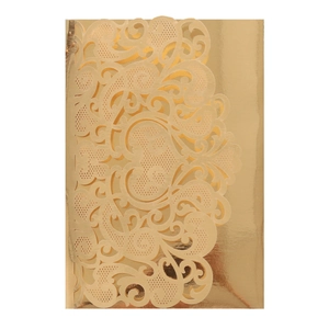 Close-up of laser-cut golden wedding invitation sleeve with floral heart patterns