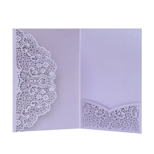 Detail of laser-cut lavender invitation showing intricate lace edges and inner pocket