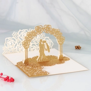 Detail of 3D pop-up wedding card featuring a glitter gold rose arch and couple silhouette