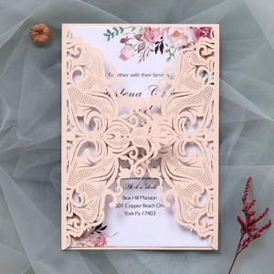 Detailed laser-cut blush pink wedding invitation with floral card and delicate bow