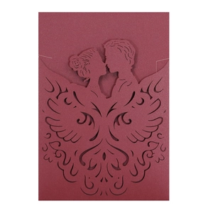 Macro detail of laser-cut burgundy wedding invitation with pearlescent finish and couple design