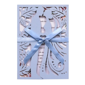 Elegant laser-cut light blue wedding invitation featuring couple silhouette and blue ribbon bow