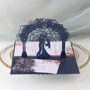 3D laser cut wedding invitation with navy blue floral arch and couple silhouette