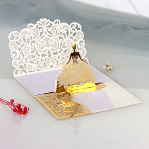 Macro detail of laser-cut lace floral patterns and 3D silhouette on wedding card