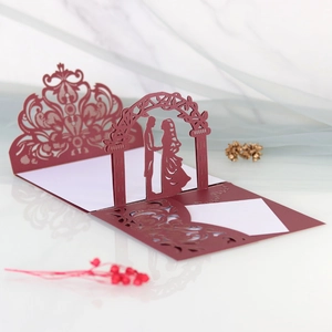 Detail of burgundy 3D pop-up wedding card with laser-cut lace and bridal silhouette