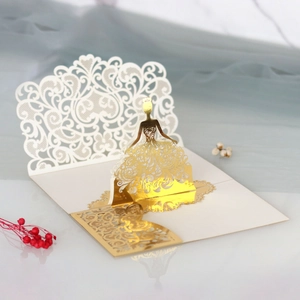 Detail of 3D laser cut wedding invitation with elegant gold crown girl silhouette
