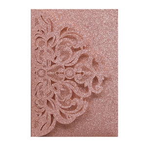Detailed laser-cut rose gold glitter wedding invitation sleeve with floral lace patterns