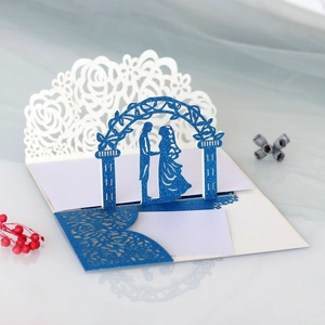 Detail of laser-cut wedding card featuring 3D romantic couple and blue glitter finish
