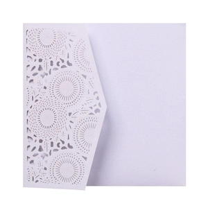 Detail of light purple laser cut wedding invitation with intricate lace flower pattern