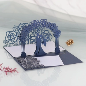 Detailed laser-cut rose arch and wedding couple silhouette on premium navy invitation