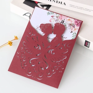 Laser-cut red wedding invitation with couple silhouette and floral inner card details