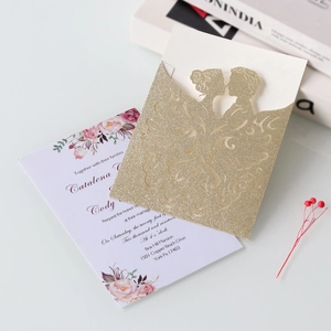 Detailed laser-cut wedding invitation featuring golden glitter sleeve and floral inner card