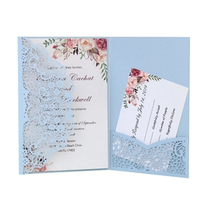 Laser cut light blue wedding invitation set with delicate lace patterns and floral cards