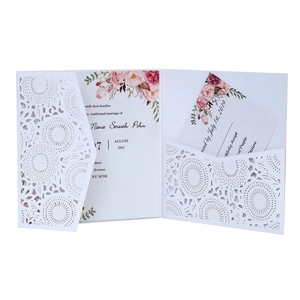 Elegant laser-cut white wedding invitation set with floral print and inner cards