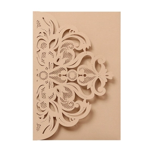 Detailed laser-cut baroque pattern on champagne gold pearlized paper wedding invitation