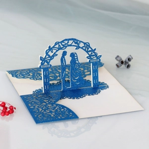 Detail of 3D laser cut wedding card showing blue glitter bride and groom silhouette