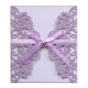 Lavender laser-cut wedding invitation with intricate vine pattern and elegant ribbon bow