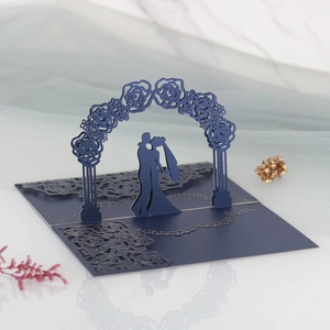 Detail of 3D laser-cut wedding card featuring a navy blue rose arch and couple silhouette