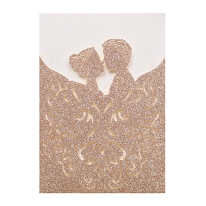 Close-up of laser cut rose gold glitter wedding invitation with kissing couple silhouette