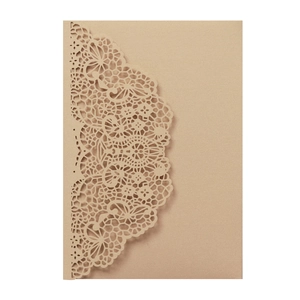 Detail of laser-cut floral pattern on kraft paper wedding invitation card