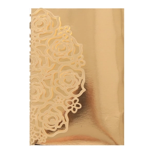 Close-up of golden laser-cut rose hollow pattern on elegant wedding invitation card