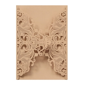 Detailed laser-cut butterfly lace pattern on natural brown kraft paper wedding invitation