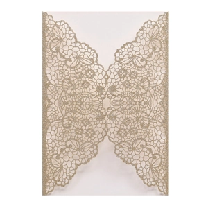 Macro detail of laser-cut wedding invitation featuring gold glitter and lace patterns