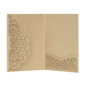 Detailed laser-cut lace pattern on gold pearlescent paper for wedding invitations