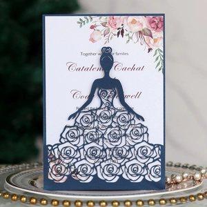 Macro detail of laser-cut rose girl wedding invitation with soft floral inner sheet