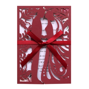 Laser cut burgundy wedding invitation card with elegant couple silhouette and silk ribbon