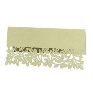 Close-up of laser-cut leaf pattern on pearlescent cardstock for wedding table settings