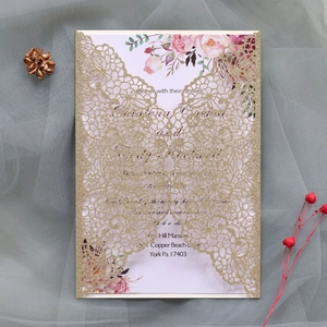 Detail of glitter gold laser-cut butterfly wedding invitation with floral inner card