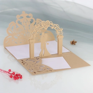 Macro detail of laser-cut 3D wedding invitation with champagne floral arch and couple silhouette
